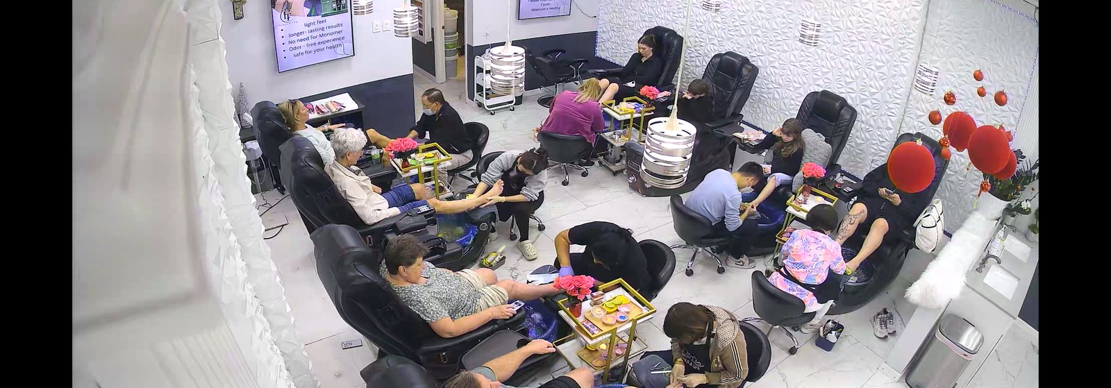 Inside LT Nails & Spa — guests being served at every spa pedicure chair